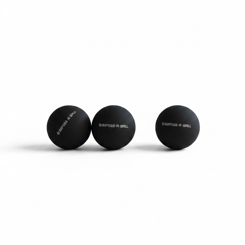 IMPOSS-A-BALL replacement rubber balls 3 pack on white surface with dramatic lighting